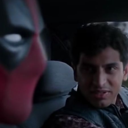 Karan Soni is talking to Deadpool as he is driving.